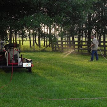 Safari Pest Control - a man spraying a field with a spray gun - Pest Control Near Me Safari Pest Control - a man spraying a field with a spray gun - Pest Control Near Me