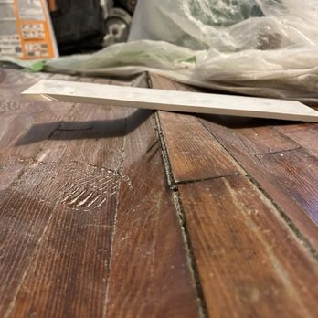 Kt Carpentry - Tile laid across floor to show damage done by leaving water on floor under plastic and tarp for several days - Carpenters Near Me - Clinton, Indiana Kt Carpentry - Tile laid across floor to show damage done by leaving water on floor under plastic and tarp for several days - Carpenters Near Me - Clinton, Indiana