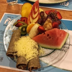 Cora Breakfast and Lunch - Cora: buckwheat crèpe wrapped sausages and fresh fruits