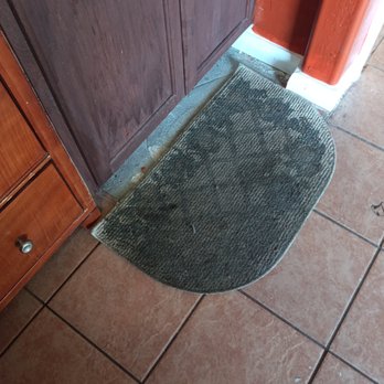 Magnuson Hotel - Disgusting filthy rug covering a missing tile on the floor - Hotels Near Me - Cedar City, Utah