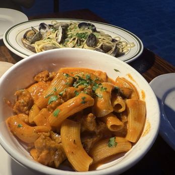 IL Brigante - Rigatoni Funghi e Salsiccia (front) and Spaghetti alle Vongole Veraci (back) - Italian Near Me - New York, New York IL Brigante - Rigatoni Funghi e Salsiccia (front) and Spaghetti alle Vongole Veraci (back) - Italian Near Me - New York, New York