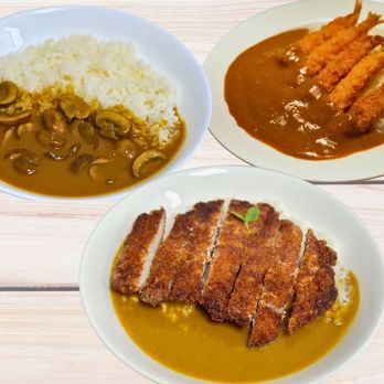 Hi Curry - three plates of food on a wooden table - Japanese Curry Near Me - Costa Mesa, California