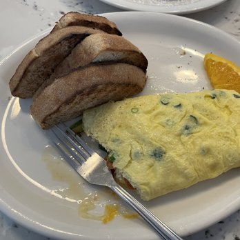 Moke’s Bread And Breakfast - Veggie omelet (no mushrooms) with a large bite taken out of the left side. Side of wheat toast. - Breakfast & Brunch Near Me - Honolulu, Hawaii Moke’s Bread And Breakfast - Veggie omelet (no mushrooms) with a large bite taken out of the left side. Side of wheat toast. - Breakfast & Brunch Near Me - Honolulu, Hawaii