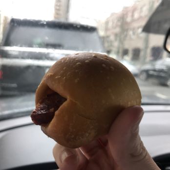 Bistro to Go - a person holding a hot dog in a bun - American Near Me - Shreveport, Louisiana Bistro to Go - a person holding a hot dog in a bun - American Near Me - Shreveport, Louisiana