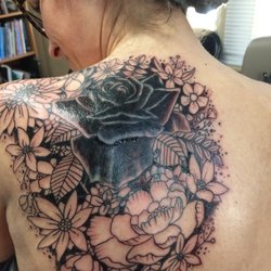 Rising Phoenix Tattooing And Body Piercing - After-the shading is the worst part! I love how he left bits of the old tattoo to let it's color lend depth to the black rose centerpiece.