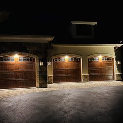 Outdoor Lighting Perspectives - Garage door lighting. Lights the size of a quarter, mounted in the door frame.