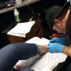Alien Ink Tattoo & Body Piercing - Jim working on my sister