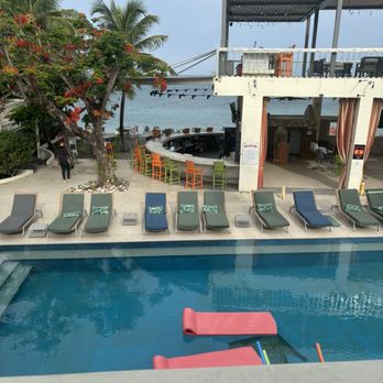 The Fred - Pool area, chaise lounge chairs in a row. Notice the elevated observation deck over the bar area. - Resorts Near Me - Frederiksted, Virgin Islands