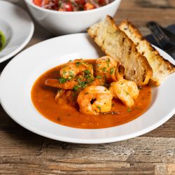 Mali Ston Wine Bar  - Garlic Prawns  Succulent prawns simmered in a rich garlic and tomato sauce, served with toasted focaccia for dipping.