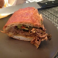 Lola's Handcrafted Kitchen - Half of the Chicago beef (spicy). Eat quickly or the jus will soak the bread!