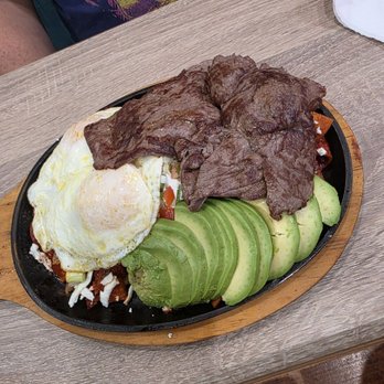Eggs & Waffles - Red chilaquilles with carne asada on over easy eggs - Breakfast & Brunch Near Me - Gilroy, California Eggs & Waffles - Red chilaquilles with carne asada on over easy eggs - Breakfast & Brunch Near Me - Gilroy, California