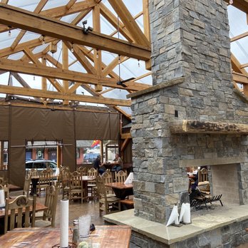 Big Cat Cafe - a stone fireplace in the middle of a restaurant - Bars Near Me - Darby, Montana