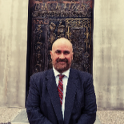 Law Office of Barry Klopfer - This is a photo of attorney Barry Klopfer standing in front of the striking pillars at the Albuquerque Metropolitan Courthous...