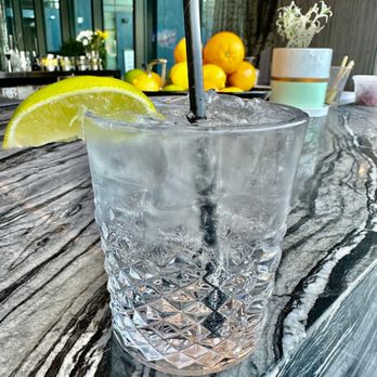 AC Lounge - a glass of water with a straw and a slice of lemon - Lounges Near Me - Washington, DC, District of Columbia