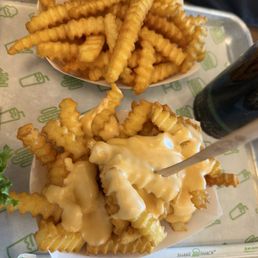 Crinkle cut fries and with cheese sauce Crinkle cut fries and with cheese sauce