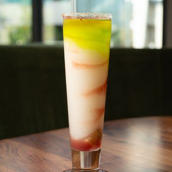 Mi Cocina - a colorful drink on a wooden table - Tex-Mex Near Me - McKinney, Texas Mi Cocina - a colorful drink on a wooden table - Tex-Mex Near Me - McKinney, Texas
