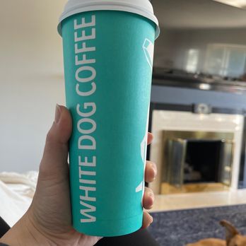White Dog Coffee - a person holding a coffee cup - Coffee & Tea Near Me - Spokane, Washington