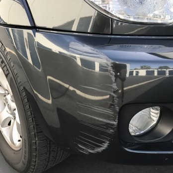 Dan The Bumper Man - Before DTBM - Huge scrape to the front right of my bumper. It was pretty deep, and had started cracking further along the bumper. - Body Shops Near Me
