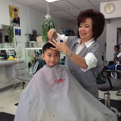 Family Haircuts - Kid friendly shop.  Happy kid getting a haircut by Lynn