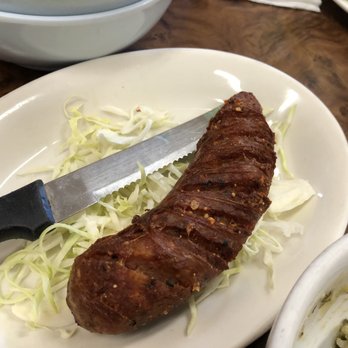 Vientian Cafe - Sai Ooa or Sai Uoa - Baked Laotian sausage made from coarsely chopped fatty pork seasoned herbs and spices - Vietnamese Near Me - Oakland, California Vientian Cafe - Sai Ooa or Sai Uoa - Baked Laotian sausage made from coarsely chopped fatty pork seasoned herbs and spices - Vietnamese Near Me - Oakland, California