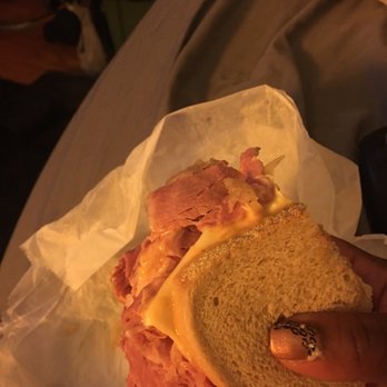 AP Deli - a person holding a sandwich with ham and cheese - Delis Near Me - Chicago, Illinois