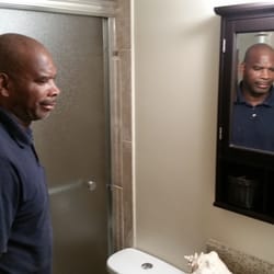 Biggins Construction - Charlie Biggins inspecting finished bathroom remodel