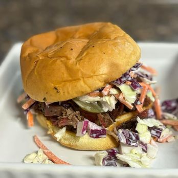 PDG Barbecue - The PDG Sandwich! Grilled bun with your choice of meat, sauce, pickles, and then topped with our Housemade Coleslaw! - Barbeque Near Me - Waco, Texas PDG Barbecue - The PDG Sandwich! Grilled bun with your choice of meat, sauce, pickles, and then topped with our Housemade Coleslaw! - Barbeque Near Me - Waco, Texas