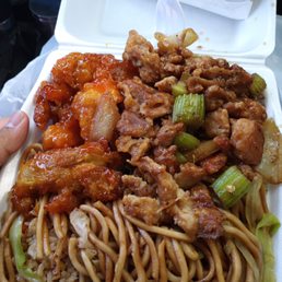 Half and half mein and rice with orange chicken and pepper chicken, also got to egg rolls