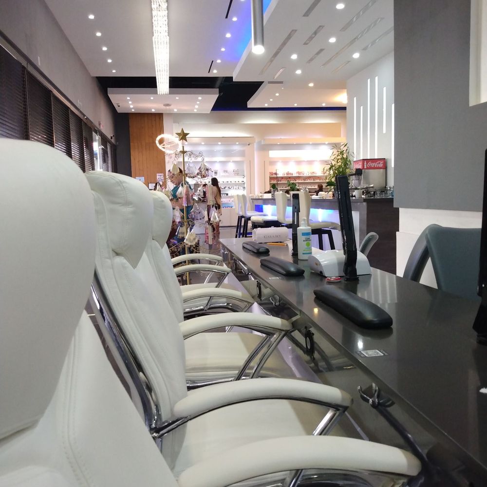 Nail booths in the front, bar to the right, receptionist far back middle.