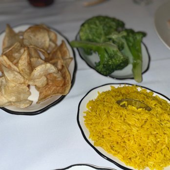 Real Madrid Restaurant - a plate of yellow rice, broccoli, and tortillas - Spanish Near Me - Staten Island, New York