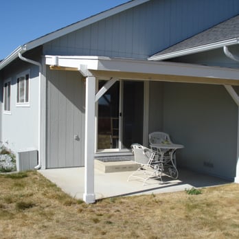 Abeyta Remodeling & Construction - a patio with a table and chairs - General Contractors Near Me