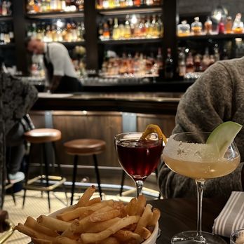 The Gage - Truffle Fries, penicillin (lighter drink), jabberwock (darker drink) - New American Near Me - Chicago, Illinois The Gage - Truffle Fries, penicillin (lighter drink), jabberwock (darker drink) - New American Near Me - Chicago, Illinois