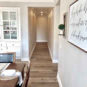 DP Floor Covering - a long hallway with a table and chairs - Flooring Near Me