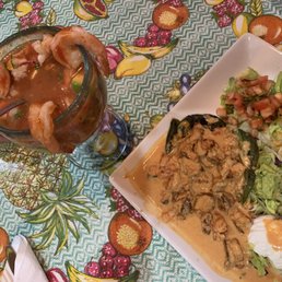 Cocktail de camarones on left and chilles rellenos on right. Cocktail de camarones on left and chilles rellenos on right.