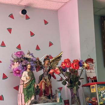 Tutty Frutty - a vase of flowers and statues - Mexican Near Me - Austin, Texas Tutty Frutty - a vase of flowers and statues - Mexican Near Me - Austin, Texas