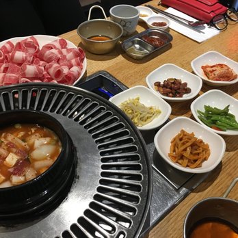 Kobi Korean BBQ - Thin-sliced beef, along with side dishes and a bowl of spicy soup. - Barbeque Near Me - Vaughan, Ontario Kobi Korean BBQ - Thin-sliced beef, along with side dishes and a bowl of spicy soup. - Barbeque Near Me - Vaughan, Ontario