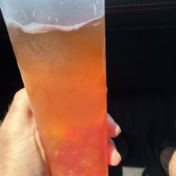 Green tea, pineapple chunks with strawberry and mango popping boba Green tea, pineapple chunks with strawberry and mango popping boba
