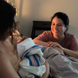 Mother with newborn and doula Mother with newborn and doula