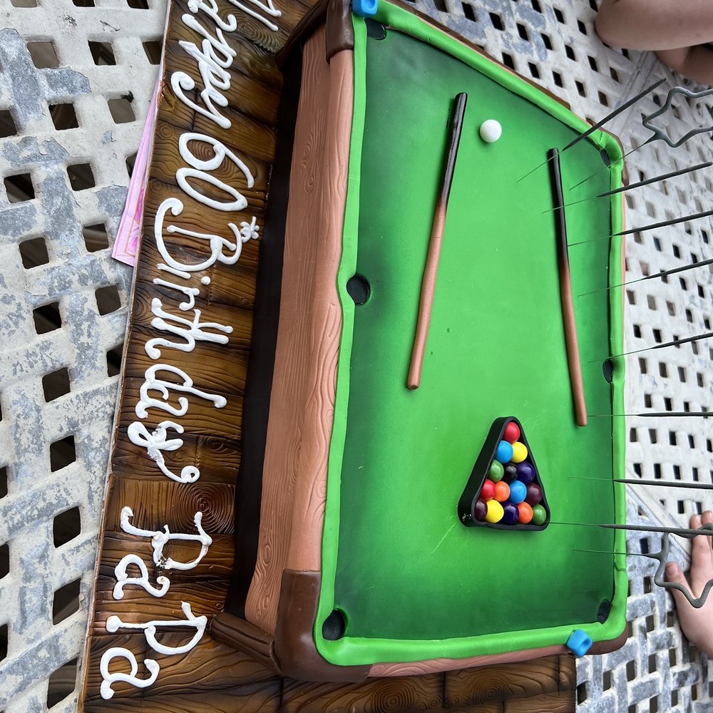 a pool table with pool balls and cues