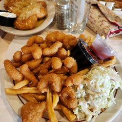 Fried shrimp, french fries coleslaw, tartar sauce, and shrimp sauce