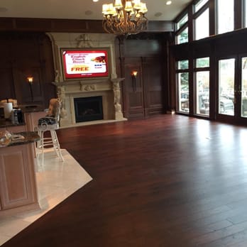 Suburban Floors - a large living room with a fireplace - Flooring Near Me Suburban Floors - a large living room with a fireplace - Flooring Near Me