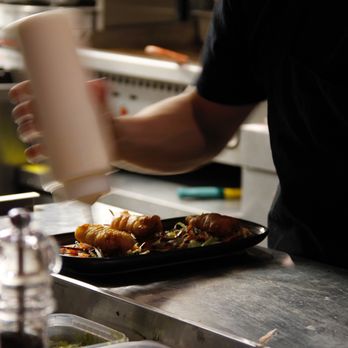 Caifan - a chef preparing food in a commercial kitchen - Mexican Near Me - Montreal, Quebec