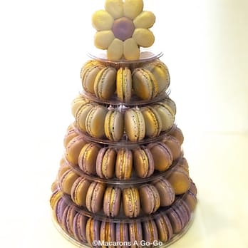 Macarons A Go-Go - Ombré macaron tower in shades of purple with a splash of gold and a flower as a topper - Macarons Near Me Macarons A Go-Go - Ombré macaron tower in shades of purple with a splash of gold and a flower as a topper - Macarons Near Me