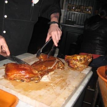 Amada - chef cutting up whole suckling pig tableside - Tapas Bars Near Me - Philadelphia, Pennsylvania