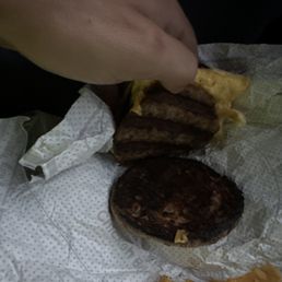 ows a person taking a bite out of a hamburger