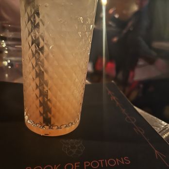 Amazonia - a glass of lemonade on a book of potions - Cocktail Bars Near Me - Lakewood, Ohio