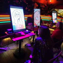 (4) Over the Line artists drawing digital caricatures at our corporate holiday party at Dreamland Diner in Fremont.