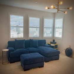 A Royal Suite Home Furnishings - Blue couch with a chase for the movie room.