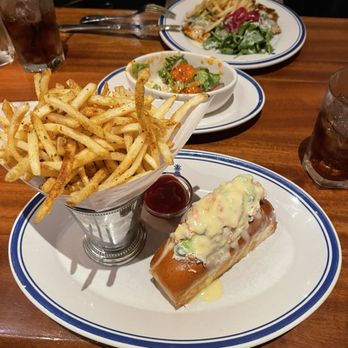 Hudson House - Lobster Roll with Fries in the front and French Chicken in the back. - Seafood Near Me - Irving, Texas