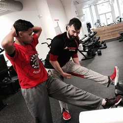 Parisi Speed School Chicago - Coach Brennan leading a recovery and stretching session with an athlete for private training.